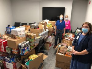 Patient and Family Volunteers and Duke staff members pose with food drive donations